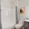 The Monaco at Waterford Lakes, Orlando, Florida bathroom with wood-style flooring and custom framed mirror