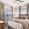 The Monaco at Waterford Lakes, Orlando, Florida bedroom with woo-style flooring, ceiling fan and large windows